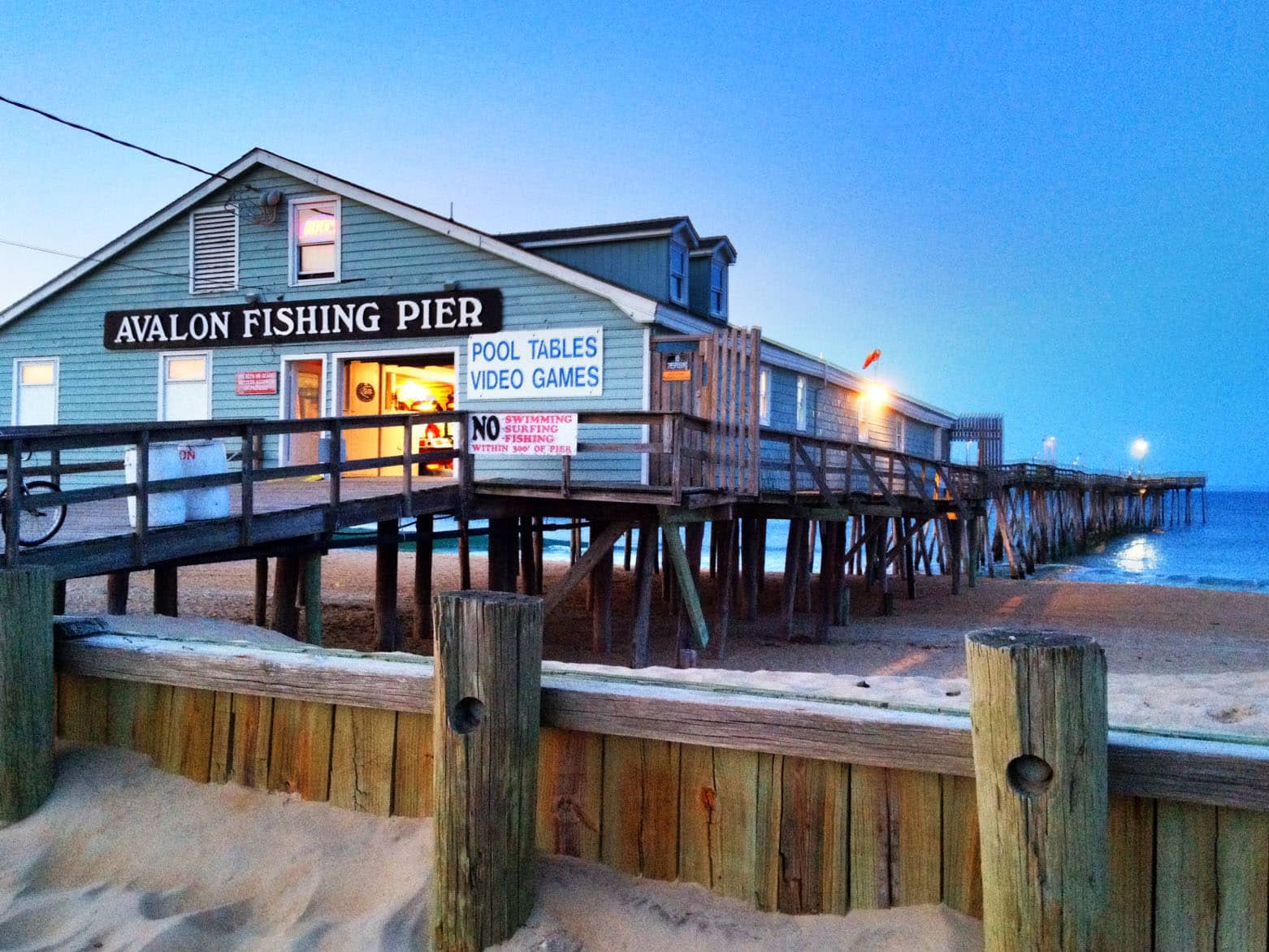 Avalon Fishing Pier in Kill Devil Hills at dusk, the pier running out over the ocean — Outer Banks, NC